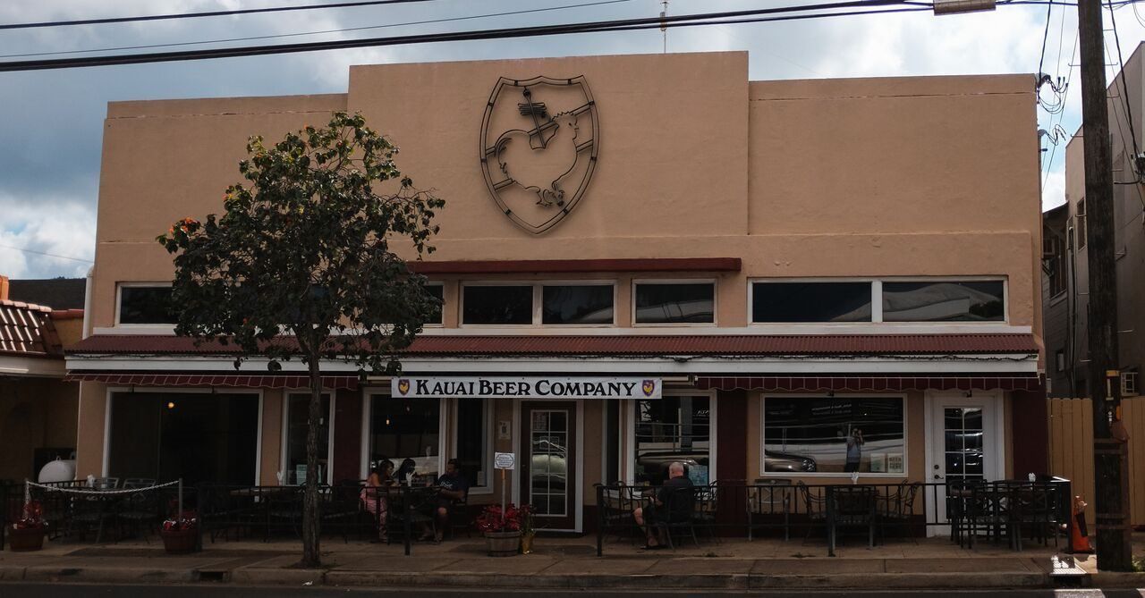 The Kauai Beer Company building on Rice Street, Lihue, with the rooster shield above the entrance